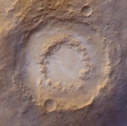 Lowell Crater, 202 kilometers (126 miles) across, is a typical peak-ring crater. These form when the impact is big enough to blast a crater at least 100 km (60 mi) wide. Instead of a single central peak, they develop a ring of peaks, hence the name. (NASA/JPL-Caltech/Malin Space Science Systems)