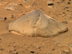 Adirondack rock, a piece of basalt about the size of a football, was the first rock examined by Mars Exploration Rover Spirit after it landed in Gusev Crater. Although it has a lot of reddish dust on its surfaces, the rock's angular shape indicates it has been eroded by wind-blown sand and dust. (NASA/JPL-Caltech/Cornell University) 