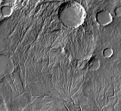 The branching channels of Warrego Valles offer evidence it once rained on Mars. The pattern, called "dendritic" (tree branch-like), branches in the same way as do streams on Earth caused by rainfall. But dendritic channel patterns are relatively rare on Mars. If it rained there, it probably wasn't very often — or for very long. (NASA/JPL-Caltech/Arizona State University)
