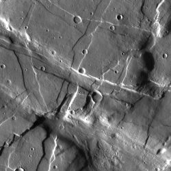 Where fractures and grabens cut across each other, scientists can determine the relative timing of the events by examining which features intersect which others. Here several fractures that trend from upper left to lower right cut across fractures trending from upper right to lower left. Which is younger? (NASA/JPL-Caltech/Arizona State University)