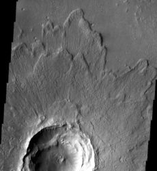 Many craters, including this 7 km (4.3 mi) one, have ejecta sheets with upraised outer rims. These form when the flying debris abruptly stops and material piles up behind it. The radial lines on the ejecta surrounding the crater rim come from superheated gas and debris surging outward after the impact. (NASA/JPL-Caltech/Arizona State University)