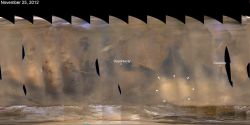 White arrows indicate a November 2012 regional dust storm on Mars, along with the positions of the Opportunity and Curiosity rovers in different parts of the planet. (NASA/JPL-Caltech/Malin Space Science Systems)